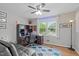 Comfortable bedroom featuring an office area, ceiling fan and a large window at 5144 Jeffries St, Raleigh, NC 27606