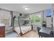Bedroom with wooden floors, large windows, a bunk bed and a desk area at 5144 Jeffries St, Raleigh, NC 27606