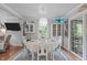 Charming dining room with hardwood floors, stylish lighting, and sliders to rear deck at 5144 Jeffries St, Raleigh, NC 27606
