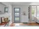Bright entryway featuring stylish decor, wood floors, and a modern door with glass panels at 5144 Jeffries St, Raleigh, NC 27606