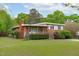 Charming single-Gathering home with a brick facade, covered porch, and large front lawn at 5144 Jeffries St, Raleigh, NC 27606