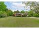Lovely brick home featuring a covered porch, mature trees and well-kept lawn at 5144 Jeffries St, Raleigh, NC 27606