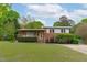 Charming brick two-story home with manicured lawn and mature trees in a quiet neighborhood at 5144 Jeffries St, Raleigh, NC 27606