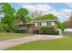Traditional brick home with covered porch, updated windows, and a long driveway at 5144 Jeffries St, Raleigh, NC 27606