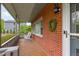 Inviting front porch with rocking chairs, brick accent wall, and charming outdoor lighting at 5144 Jeffries St, Raleigh, NC 27606