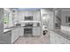 Well-lit kitchen featuring stainless steel appliances, granite countertops, and white cabinets at 5144 Jeffries St, Raleigh, NC 27606