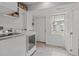 Clean laundry room featuring a washer, dryer, storage, and access to the backyard at 5144 Jeffries St, Raleigh, NC 27606