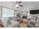 Inviting living room with a plush sectional, brick fireplace, and a ceiling fan at 5144 Jeffries St, Raleigh, NC 27606