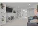 Spacious living area with plush carpeting, stylish console, and a mounted flat screen television at 5144 Jeffries St, Raleigh, NC 27606