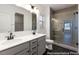 Bathroom featuring double vanity, a glass walk-in shower, and modern fixtures at 517 W Brocklyn St # 63P, Benson, NC 27504