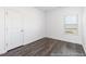 This bedroom features wood flooring, a window and a standard closet door at 517 W Brocklyn St # 63P, Benson, NC 27504