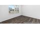 Bedroom with natural lighting, hardwood floors, and window blinds at 517 W Brocklyn St # 63P, Benson, NC 27504