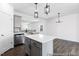 Well-lit kitchen featuring an island, gray cabinets, stainless steel appliances, and modern lighting at 517 W Brocklyn St # 63P, Benson, NC 27504