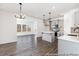 Spacious open concept kitchen, island, and dining area with modern fixtures and gray cabinets at 517 W Brocklyn St # 63P, Benson, NC 27504