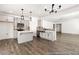 Modern kitchen with gray cabinets, stainless steel appliances, backsplash, island and sleek pendant lighting at 517 W Brocklyn St # 63P, Benson, NC 27504