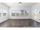 Bright living room with multiple windows and glass door providing natural light and outdoor views at 517 W Brocklyn St # 63P, Benson, NC 27504