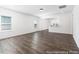 Open living space with hardwood floors, bright light, and a view into the kitchen at 517 W Brocklyn St # 63P, Benson, NC 27504