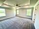 Spacious main bedroom boasts natural light, a ceiling fan, and plush carpet at 536 Bishop Ln, Sanford, NC 27330