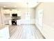 Cozy dining area with bright, natural light, modern lighting, and lovely wainscoting, adjoining the kitchen at 538 Middleton Ct, Sanford, NC 27330