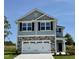 Beautiful two-story home with stone accents, a two-car garage, and manicured landscaping under a bright blue sky at 538 Middleton Ct, Sanford, NC 27330