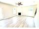 Bright, open living room with a cozy fireplace, ceiling fan, and large windows with views of outside at 538 Middleton Ct, Sanford, NC 27330