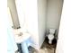 Compact powder room with a pedestal sink, modern fixtures, and a clean, minimalist design at 538 Middleton Ct, Sanford, NC 27330