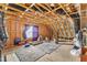 Unfinished attic space showcasing exposed beams, a window, and ample room for storage at 5525 Garnet Meadow Rd, Knightdale, NC 27545