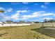 Vast backyard with a basketball hoop, lush green lawn, and a view of the surrounding homes at 5525 Garnet Meadow Rd, Knightdale, NC 27545