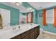 Bright bathroom featuring a double vanity, ample counter space, and colorful decor at 5525 Garnet Meadow Rd, Knightdale, NC 27545