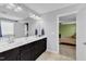 Bathroom with double sinks, granite countertop, and dark wood cabinets at 5525 Garnet Meadow Rd, Knightdale, NC 27545