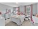 Cozy bedroom with natural light, white furniture, and pink accents at 5525 Garnet Meadow Rd, Knightdale, NC 27545