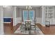 Formal dining room with wood floors, decorative rug, wooden chairs, and a chandelier hanging over the round table at 5525 Garnet Meadow Rd, Knightdale, NC 27545