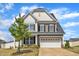 Inviting two-story home featuring a two-car garage, well-manicured lawn, and beautiful landscaping at 5525 Garnet Meadow Rd, Knightdale, NC 27545