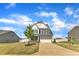 Beautiful home with a two-car garage, manicured lawn, and a young tree in the front yard at 5525 Garnet Meadow Rd, Knightdale, NC 27545