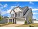 Lovely two-story home with a well-kept lawn, mature landscaping, and a convenient two-car garage at 5525 Garnet Meadow Rd, Knightdale, NC 27545