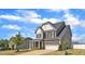Charming two-story home with a well-kept lawn, mature tree, and a two-car garage at 5525 Garnet Meadow Rd, Knightdale, NC 27545