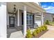 Inviting front porch with seating area and decorative lighting, perfect for relaxing and enjoying the outdoors at 5525 Garnet Meadow Rd, Knightdale, NC 27545