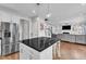 Open concept kitchen with island seating flows into living area; great for entertaining at 5525 Garnet Meadow Rd, Knightdale, NC 27545
