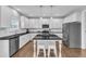 Modern kitchen featuring white cabinetry, a dark countertop, and stainless steel appliances at 5525 Garnet Meadow Rd, Knightdale, NC 27545