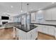 Bright kitchen with stainless appliances, island with seating, and easy access to the living room at 5525 Garnet Meadow Rd, Knightdale, NC 27545