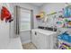 Practical laundry room with shelving, washer, dryer, and a convenient folding area at 5525 Garnet Meadow Rd, Knightdale, NC 27545