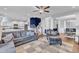 Cozy living room with stylish sofa, staircase, dark accent wall, and an open view to the kitchen at 5525 Garnet Meadow Rd, Knightdale, NC 27545