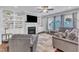 Spacious living room with a fireplace, built-in shelving, comfortable seating, and natural light from the windows at 5525 Garnet Meadow Rd, Knightdale, NC 27545