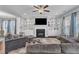 Large living room with built in shelving, dark fireplace, modern furniture and windows for natural light at 5525 Garnet Meadow Rd, Knightdale, NC 27545