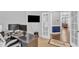 Bright home office space with large monitors, dark desk, and an open doorway leading to a furnished living area at 5525 Garnet Meadow Rd, Knightdale, NC 27545