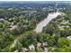 An aerial view highlights a lakeside neighborhood with mature trees and 6 Chelan Ct Durham at 6 Chelan Ct, Durham, NC 27713