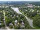 Aerial view of the property at 6 Chelan Ct Durham, nestled by a lake at 6 Chelan Ct, Durham, NC 27713