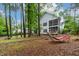 Spacious backyard featuring a screened porch, patio furniture, and lush greenery, creating a peaceful retreat at 6 Chelan Ct, Durham, NC 27713