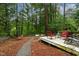 Wooded backyard with a patio, a hammock, and lush greenery, ideal for relaxation at 6 Chelan Ct, Durham, NC 27713
