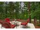 Wooded backyard featuring a hammock, patio furniture, and a lush green landscape at 6 Chelan Ct, Durham, NC 27713